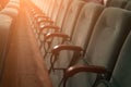 Empty auditorium of cinema or theater. Row of armchairs. Abstract toned background with selective focus Royalty Free Stock Photo