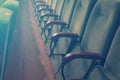 Empty auditorium of cinema or theater. Row of armchairs. Abstract toned background with selective focus Royalty Free Stock Photo