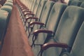 Empty auditorium of cinema or theater. Row of armchairs. Abstract toned background with selective focus Royalty Free Stock Photo