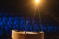 Empty auditorium with podium and speaker on stage