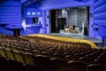 Empty auditorium and stage in the theater. Rehearsal of the play. Artists on stage Royalty Free Stock Photo