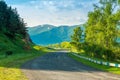 Empty automobile mountain road on a sunny summer day in the picturesque mountains of Transcaucasia Royalty Free Stock Photo