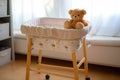 an empty baby bassinet with a soft plush toy