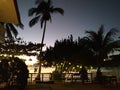 Empty backyard of hotel in Philippines islands. Tropical resort in sunset light. Wooden path in tropical patio. Exotic vacation.