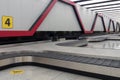 Empty baggage conveyor belt in airport at arrivals, place for disabled passengers marked with disability icon Royalty Free Stock Photo