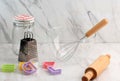 Empty Baking Bowl, Grater, Jar, Cookie Cutter, and Rolling Pin in White Marble Kitchen Royalty Free Stock Photo