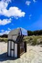 Empty Baltic sea wicker beach chair in the sand Royalty Free Stock Photo