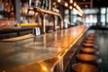 Empty bar counter with stools in a dimly-lit setting Royalty Free Stock Photo
