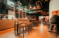 Empty bar interior with some customers in historical brewery De Koninck, craft beer pub Royalty Free Stock Photo