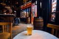 Empty bar with only one occupied table and beer glass. No visitors inside an old pub