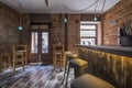 An empty bar with raw brick walls and white wooden high to Royalty Free Stock Photo