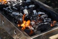Empty Barbecue Flaming Grill Close Up With Bright Flames And White firelighters burning Royalty Free Stock Photo
