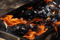 Empty Barbecue Flaming Grill Close Up With Bright Flames And White firelighters burning Royalty Free Stock Photo