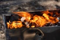 Empty Barbecue Flaming Grill Close Up With Bright Flames And White firelighters burning Royalty Free Stock Photo