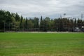 Empty baseball or softball diamond from the back fence and foul line looking towards the grass and trees in New Westminster, Royalty Free Stock Photo