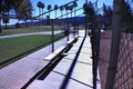 Empty baseball and softball dugout with bench at public park. Royalty Free Stock Photo