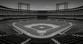 Empty Baseball Stadium Panorama A grayscale panoramic view of an empty baseball stadium showcasing the field and tiered seating Royalty Free Stock Photo