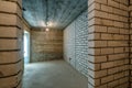 Empty basement room with minimal preparatory repairs. interior with white brick walls Royalty Free Stock Photo