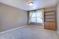 Empty basement room with wooden cabinet and beige carpet. Royalty Free Stock Photo