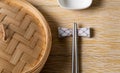 Empty basket of dim sum made by bamboo material and chopsticks. Chinese Traditional cuisine concept. Dumplings Dim Sum in bamboo Royalty Free Stock Photo