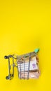 Empty empty basket on euro banknotes, on yellow background. Concept of food basket or purchasing power
