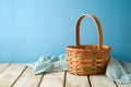 Empty basket with tablecloth on rustic wooden table over blue wall  background.  Kitchen mock up for design and product display Royalty Free Stock Photo