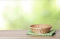 Empty basket on wooden table with copy space.Green natural product display.Food advertisement