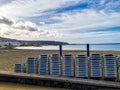 Empty beach with all sun beds piled up for closed season and zero tourists situation because coronavirus lockdown worldwide