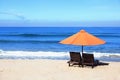 Empty beach background with bright tent, chairs, surf waves and sunny sky Royalty Free Stock Photo