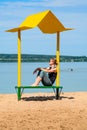 Empty beach with a bench with a canopy on the coast Royalty Free Stock Photo