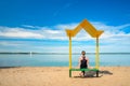 Empty beach with a bench with a canopy on the coast Royalty Free Stock Photo