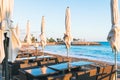 Empty beach cafe without visitor, people. Empty Beach chair, table, bay, seaside, no tourist. Travel ban in Europe. Tourist season Royalty Free Stock Photo