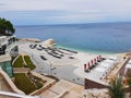 an empty beach with chairs and sea