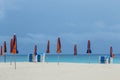 empty beach with closed parasols and stapled plastic beach couches in Fuerteventura in late evening Royalty Free Stock Photo
