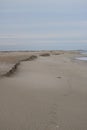 An empty beach in December with eroding dunes Royalty Free Stock Photo