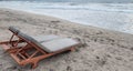 Empty beach lounger chairs facing the sea