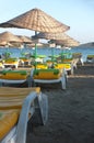 Empty beach with parasols and deck chairs Royalty Free Stock Photo