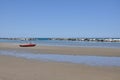 Empty beach with a red rescue boat. Royalty Free Stock Photo