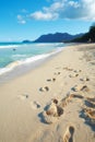 An empty beach, relaxing summer seascape for a peaceful holiday with clear blue sky copy space and footprints in the Royalty Free Stock Photo