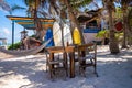 Empty beach restaurant with hammock and kayak on sand at beach