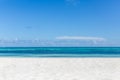 Empty beach scenery, white sand, blue sea under blue sky. Idyllic beach landscape. Tropical background Royalty Free Stock Photo