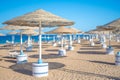 Empty beach sea sand sky and summer day. Abstract bokeh summer and sea background. People relax on sun loungers under an umbrella Royalty Free Stock Photo