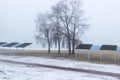 Empty beach in spring on the banks of the river, trees and shelter from the sun. Foggy Royalty Free Stock Photo