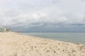 Empty beach before storm. Dramatic cloudscape. Autumn seascape. Calm weather on the seaside. Royalty Free Stock Photo