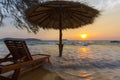 Empty beach with straw umbrella on sunrise in Koh Rong, Cambodia