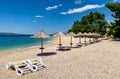 Empty beach with sun loungers and beach umbrellas in Croatian Makarska Royalty Free Stock Photo