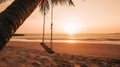 Empty beach swing in golden light at sunset or sunrise. Tranquil tropical holiday scene Royalty Free Stock Photo