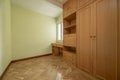 Empty bedroom with herringbone oak parquet, fitted wardrobes, desk Royalty Free Stock Photo