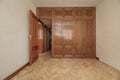 Empty bedroom with herringbone oak parquet, fitted wardrobes Royalty Free Stock Photo