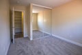 Empty bedroom with mirrored closet doors and carpet Royalty Free Stock Photo